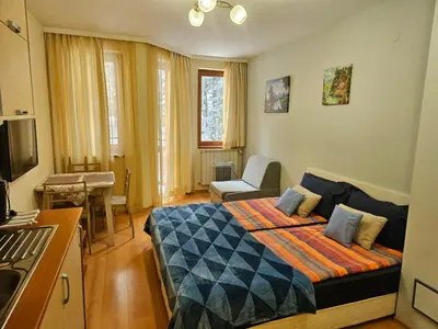 a bedroom with a bed and a living room at Borovets Hotel Villa Park in Borovets