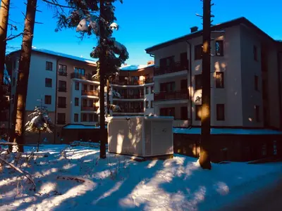 a building in the snow in front of a building at Borovets Hotel Villa Park in Borovets