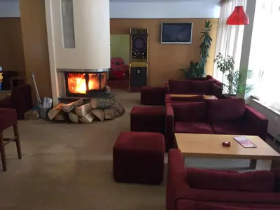 a living room with a couch and a fire place at Borovets Hotel Villa Park in Borovets