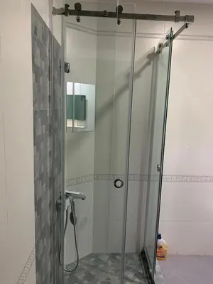 a shower with a glass door in a bathroom at Lilia 2 Self-Check in apartment in Sofia