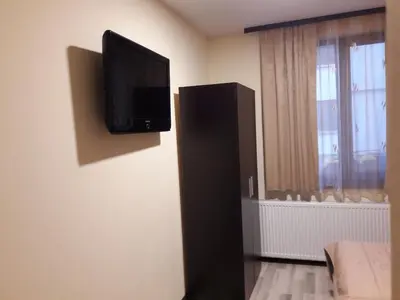 a flat screen tv on the corner of a room at Sharkova House Bansko in Bansko