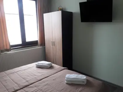a bedroom with a bed with two towels on it at Sharkova House Bansko in Bansko