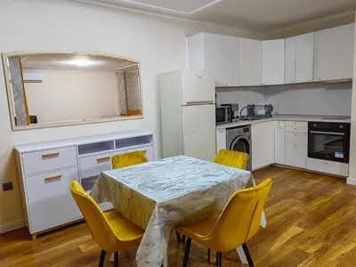a kitchen with a table and chairs in a room at Venice Apartments in Sofia