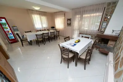 a dining room with white tables and chairs at Villa Drecheva in Ognyanovo