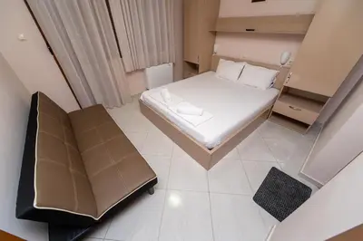 a small room with a bed and a couch at Villa Drecheva in Ognyanovo