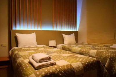 two beds in a hotel room with towels on them at Hotel Frigopan in Plovdiv