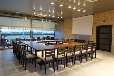 a conference room with a large table and chairs at Hotel Frigopan in Plovdiv