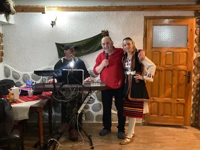 a man and a woman standing next to a keyboard at Guest House Planinski Zdravets in Bansko