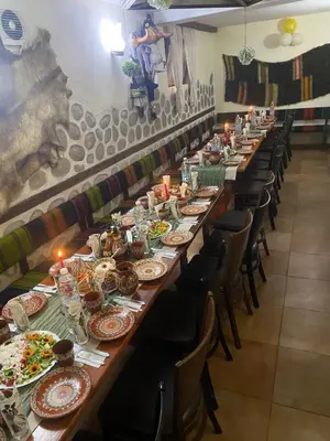 a long table with plates of food on it at Guest House Planinski Zdravets in Bansko