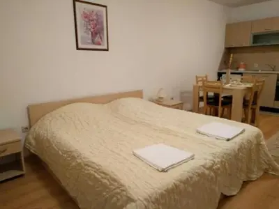 a bedroom with a bed with two towels on it at Aspen golf studio apartment D208 in Razlog