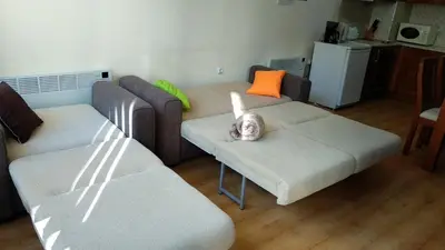 a baby sitting on a couch in a living room at Pine Tree Apartment 2 - B7 in Bansko