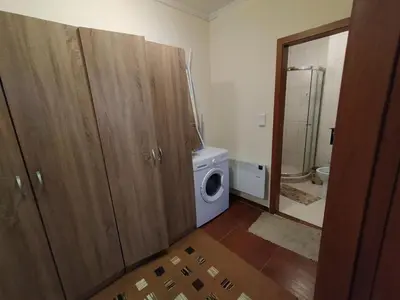 a bathroom with a washing machine and a washer at Pine Tree Apartment 3 - B3 in Bansko