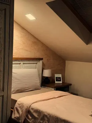 a bedroom with two beds and a table with a lamp at Boutique Guest House Yes For You in Plovdiv