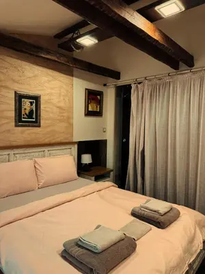 a bedroom with a bed with towels on it at Boutique Guest House Yes For You in Plovdiv