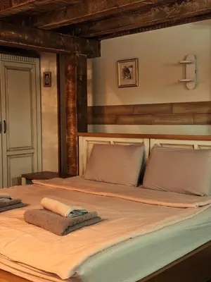 a large bed with two towels on top of it at Boutique Guest House Yes For You in Plovdiv