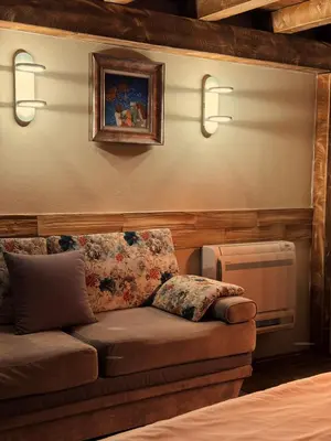 a living room with a couch and a picture on the wall at Boutique Guest House Yes For You in Plovdiv