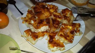 a white plate of food on a table at Guest House Ilinden in Bansko