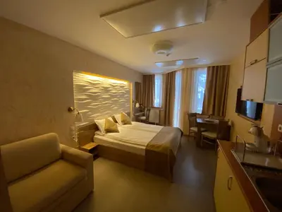 a hotel room with a bed and a couch at HQ apartments Villa Park in Borovets