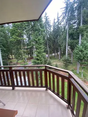 a balcony with a view of the woods at HQ apartments Villa Park in Borovets