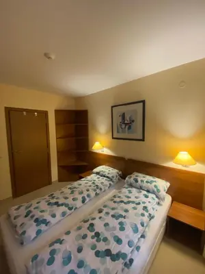 a bedroom with a bed and two pillows at HQ apartments Villa Park in Borovets