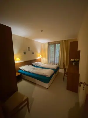 a hotel room with two beds and a window at HQ apartments Villa Park in Borovets
