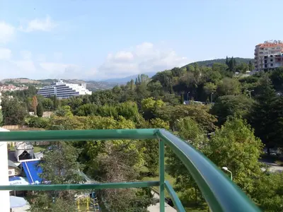 a green bridge with a view of a city at Park Apartments & Rooms Popovi in Sandanski