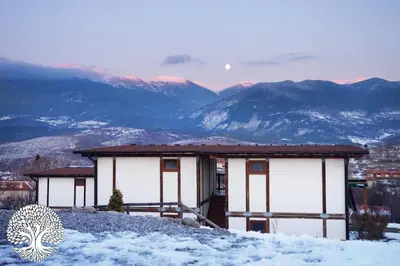 a building on top of a snow covered mountain at Debeli Dab in Stara Kresna