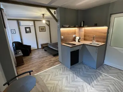 a room with a kitchen and a living room at Hot Spot Studio in the center in Sofia