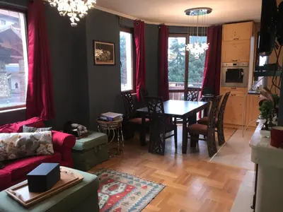 a living room with a couch and a table at Gondola Flat Number 5 in Bansko