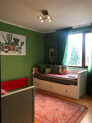 a childs bedroom with a bed and a window at Gondola Flat Number 5 in Bansko