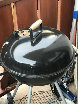 a large black grill with a wooden stick in it at Gondola Flat Number 5 in Bansko