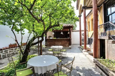 a table and chairs on the patio of a building at Guest House Old Plovdiv in Plovdiv