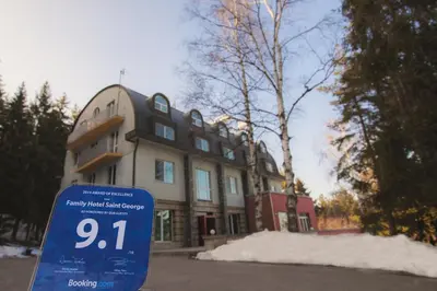 a house with a blue sign in front of it at Family Hotel Saint George in Sofia