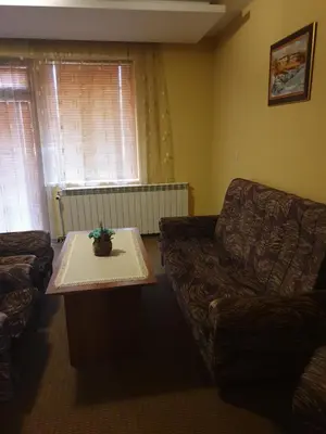 a living room with a couch and a table at Guesthouse Kiritsovi in Bansko