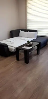 a bed and a coffee table in a room at Guest House Ideal in Sapareva Banya