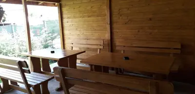 two tables and chairs in a room with a window at Guest House Ideal in Sapareva Banya