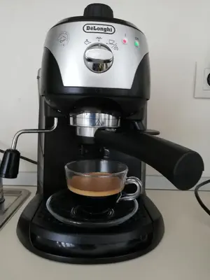 a coffee maker with a cup of coffee at Grand Monastery - Azure Apartment in Pamporovo