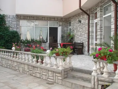 a balcony of a house with potted plants at Mania Guest House in Kalofer