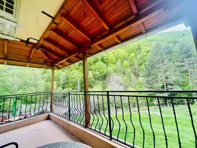 a balcony with a view of a forest at Family Hotel Gorski Kut in Rilski Manastir