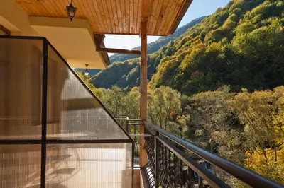 a balcony of a house with a view of a mountain at Family Hotel Gorski Kut in Rilski Manastir