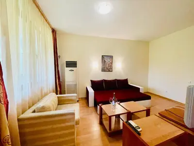 a living room with a couch and a table at Family Hotel Gorski Kut in Rilski Manastir