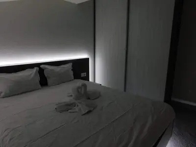 a towel sitting on top of a bed at Vihren Boutique Apartment in Bansko