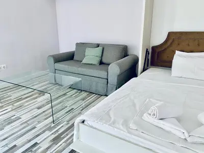 a living room with a bed and a couch at Turquoise and Magenta Apartments in Sofia