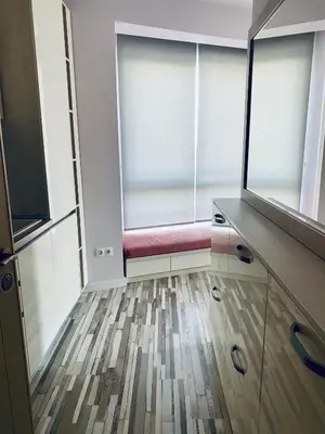 a room with a red bench in front of a window at Turquoise and Magenta Apartments in Sofia