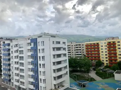 a white apartment building in a city with buildings at Turquoise and Magenta Apartments in Sofia