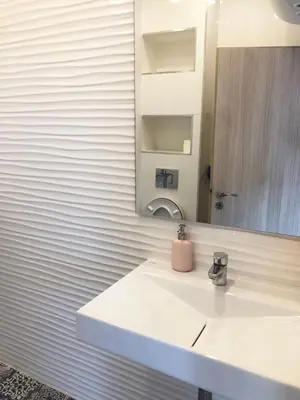 a white bathroom with a sink and a mirror at Turquoise and Magenta Apartments in Sofia