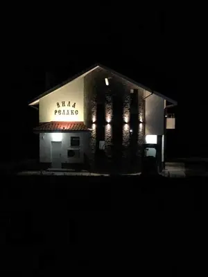 a building with a sign on it at night at VILLA RELAX in Tsigov Chark