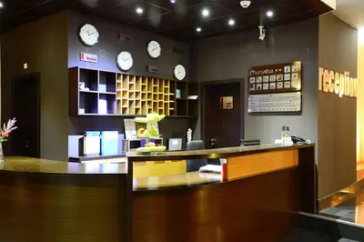 a restaurant with a counter with clocks on the wall at Hotel Mursalitsa by HMG - Half board in Pamporovo