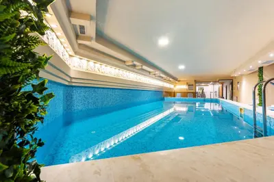 a large swimming pool with blue tiles on the walls at Hotel Mursalitsa by HMG - Half board in Pamporovo