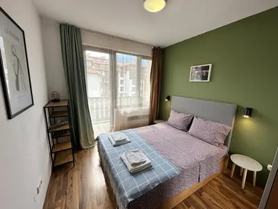 a small bedroom with a bed and a window at Ramada 2 - Apartment in Bansko